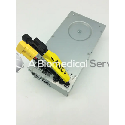 Silver metallic tripp lite hc150sl medical cart power supply 150w 120v with yellow and black cables attached