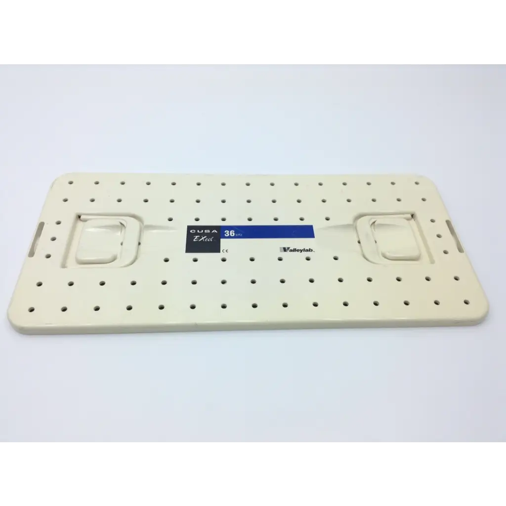 Cream-colored plastic pegboard with evenly spaced holes and side handles for valleylab cusa excel handpiece storage