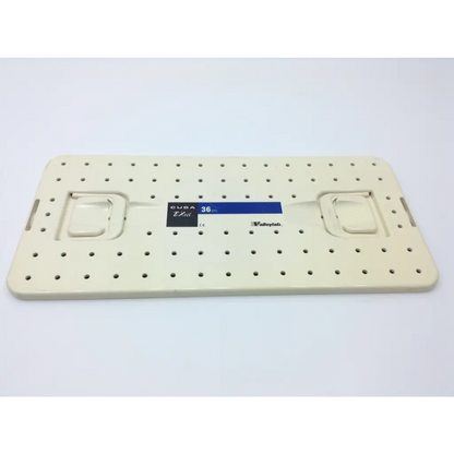 Cream-colored plastic pegboard with evenly spaced holes and side handles for valleylab cusa excel handpiece storage