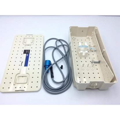 Beige plastic surgical instrument tray with perforated surface and blue cable for valleylab cusa excel handpiece