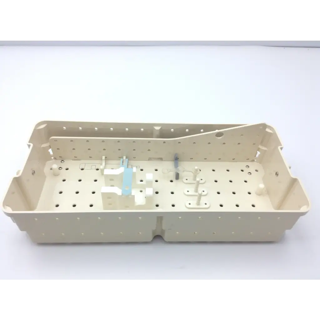Beige plastic surgical tray with perforated surface and molded compartments for valleylab cusa excel handpiece storage