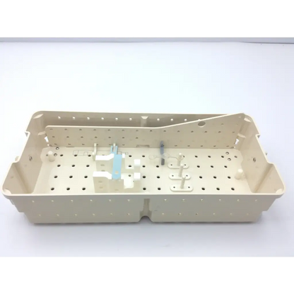 Beige plastic surgical tray with perforated surface and molded compartments for valleylab cusa excel handpiece storage