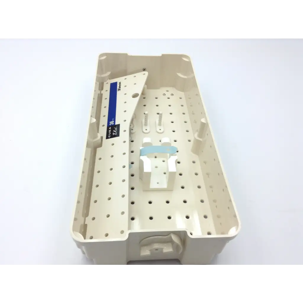 Beige plastic dental instrument tray with perforated surface and labeled compartment for valleylab cusa excel handpiece