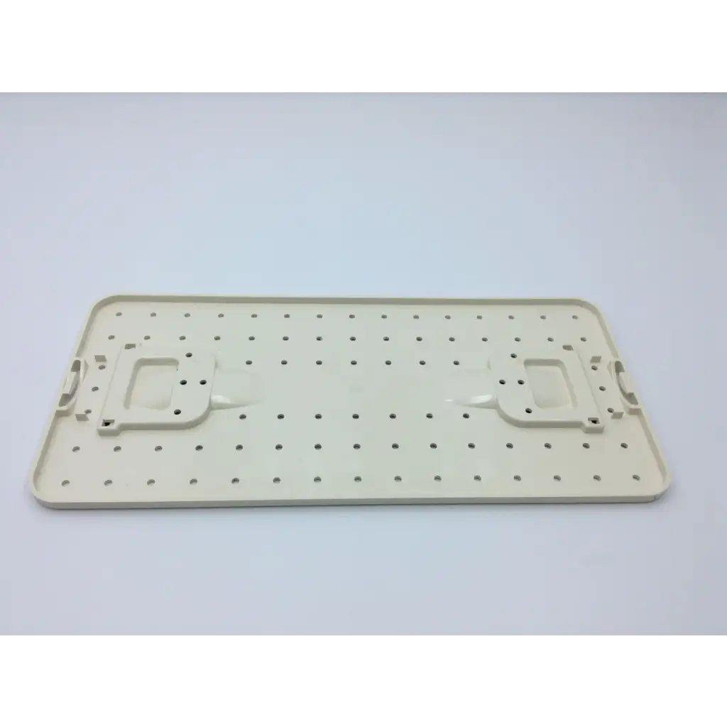 Beige plastic pegboard with evenly spaced holes and handle cutouts for valleylab cusa excel handpiece storage