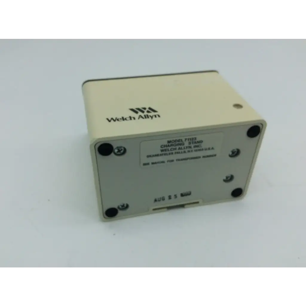 Beige welch allyn charging stand 71123 with black screw caps and printed labeling for welch allyn charging use