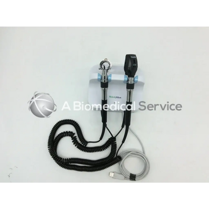 Black and silver welch allyn green series otoscope with coiled black cable and usb charging cord for wall transformer use