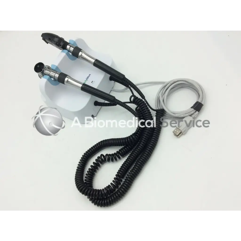 Black and silver dual-ended medical endoscope with coiled cables on white base for welch allyn green wall transformer opthalmoscope