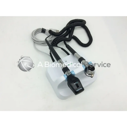 Welch allyn green series gs 777 wall transformer otoscope with white and black design and coiled cables on a white base