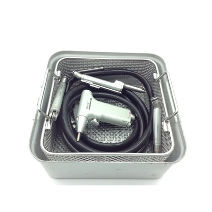 Silver halli brand dental handpiece with black coiled pneumatic hose and metallic attachments in mesh sterilization tray