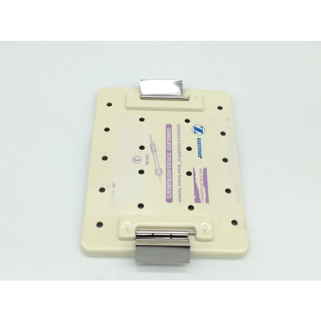 Beige plastic zimmer herbert orthopedic bone screw plate with metallic clamps and printed labeling for whipple orthopedic bone use