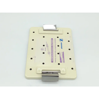 Beige plastic zimmer herbert orthopedic bone screw plate with metallic clamps and printed labeling for whipple orthopedic bone use