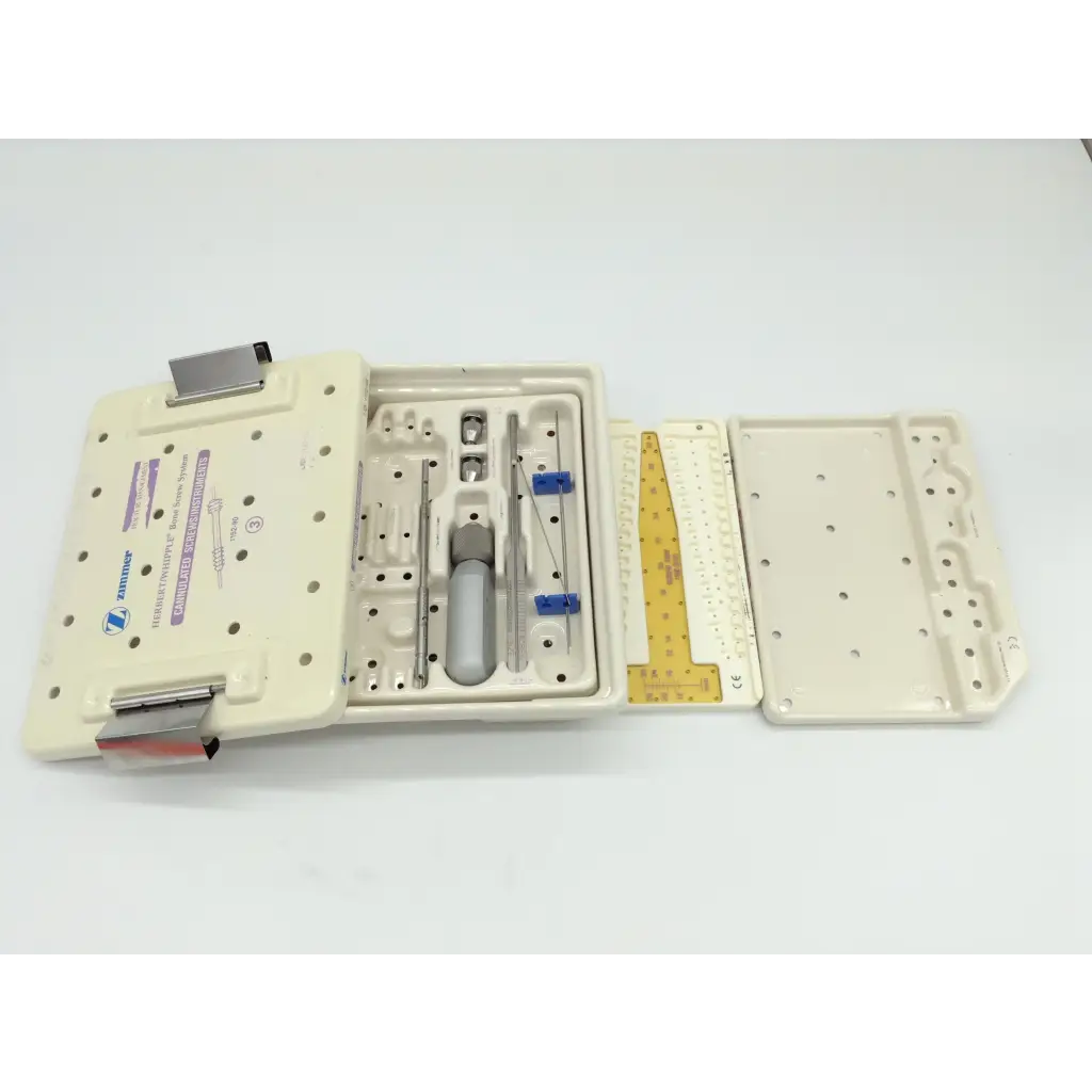 Beige plastic zimmer herbert whipple orthopedic bone screw system kit with organized metal tools and yellow measuring ruler