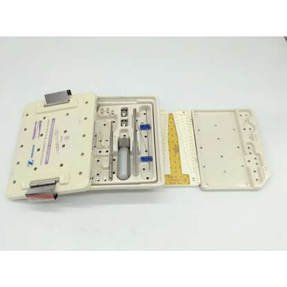 Beige plastic zimmer herbert whipple orthopedic bone screw system kit with organized metal tools and yellow measuring ruler