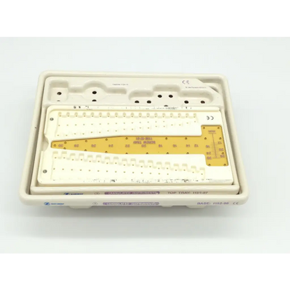 White plastic surgical instrument tray with yellow measurement scale for zimmer herbert whipple orthopedic bone screw system