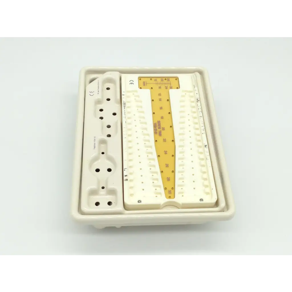 White plastic dental surgical tray with central gold metal insert engraved for zimmer herbert whipple orthopedic bone screw system