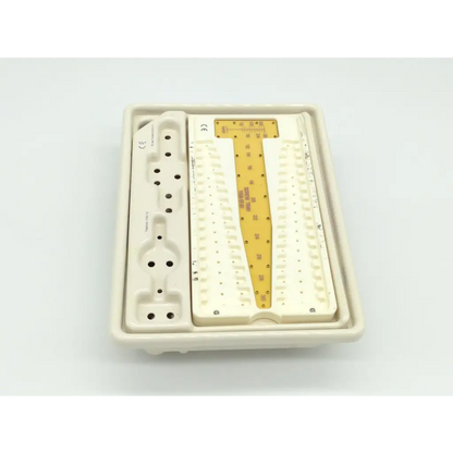 White plastic dental surgical tray with central gold metal insert engraved for zimmer herbert whipple orthopedic bone screw system